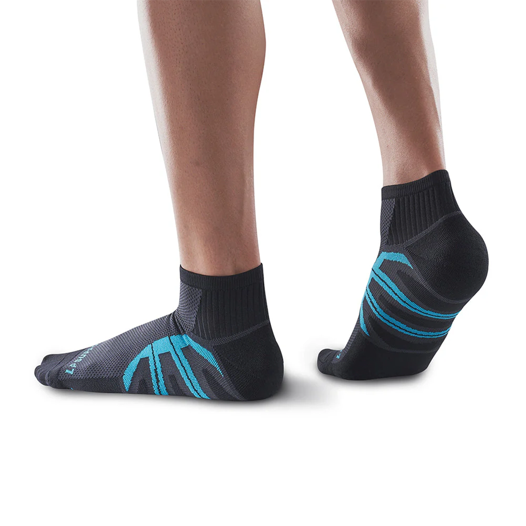 Black socks with cyan accents worn by a person on a white background
