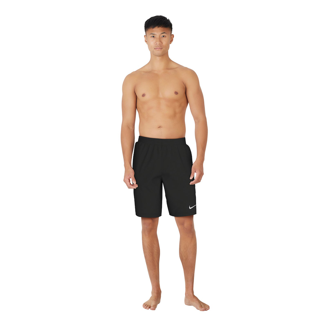 Man wearing black Nike shorts on a white background